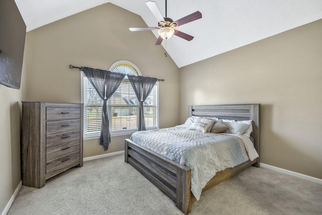 bedroom with baseboards, light carpet, high vaulted ceiling, and ceiling fan