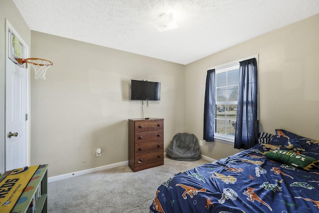 bedroom with baseboards, carpet floors, and a textured ceiling