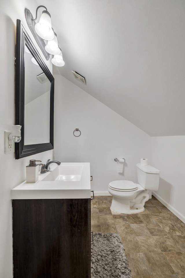 bathroom with vanity, toilet, baseboards, and visible vents