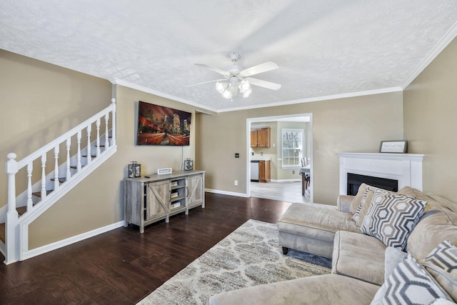 living area featuring dark wood-style floors, stairway, ceiling fan, and baseboards