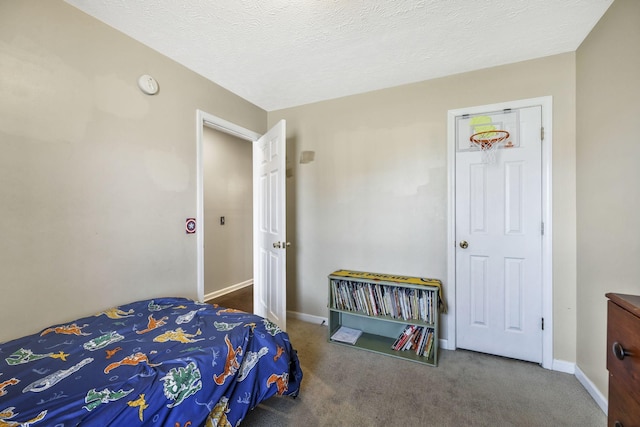 carpeted bedroom with baseboards and a textured ceiling