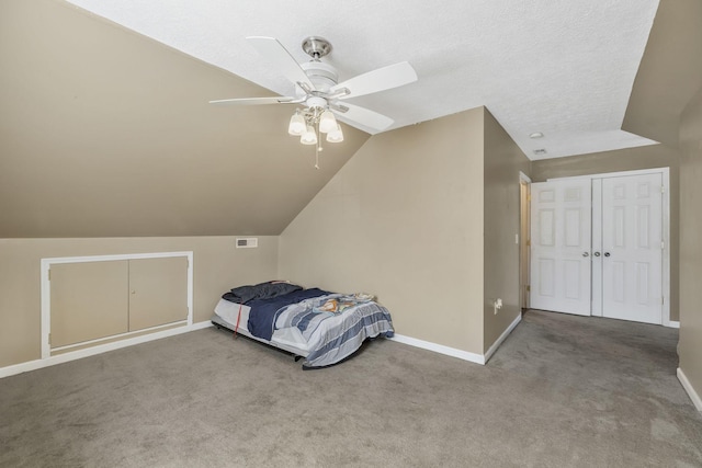 carpeted bedroom with lofted ceiling, baseboards, visible vents, and ceiling fan