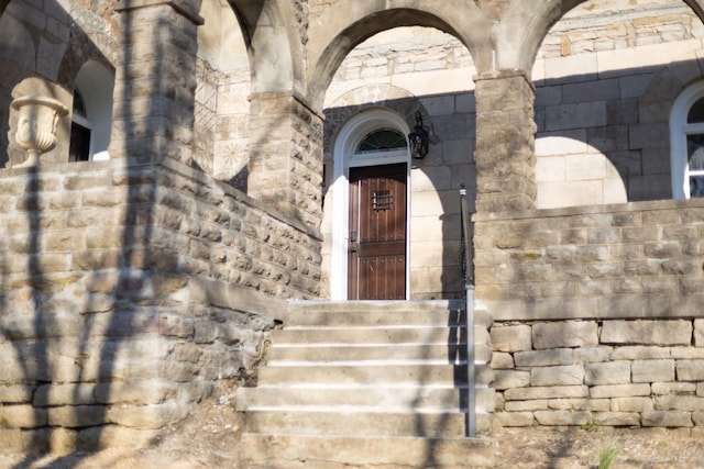 view of exterior entry featuring stone siding