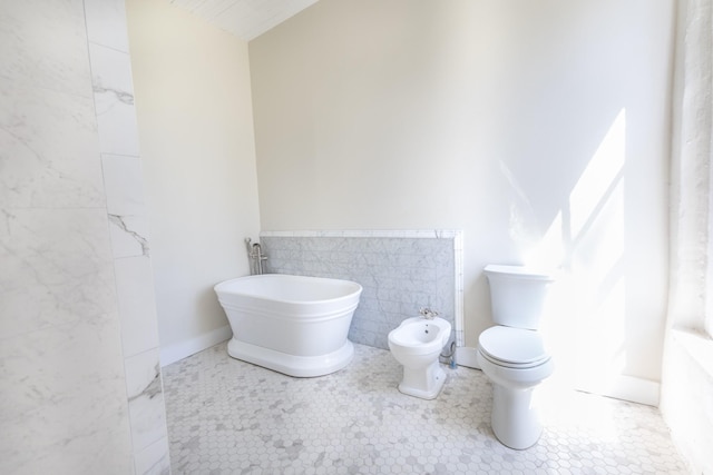 full bathroom with tile patterned floors, a bidet, toilet, and tile walls