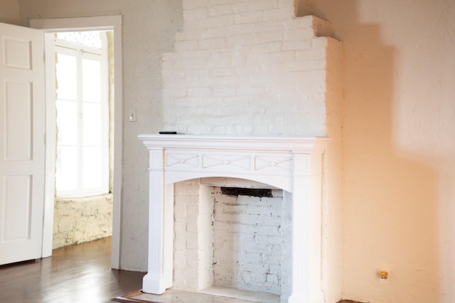 details with a fireplace and wood finished floors