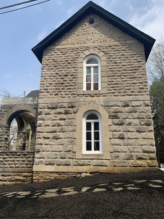 view of property exterior with stone siding