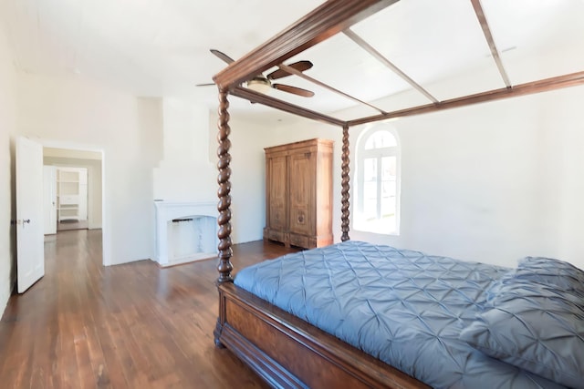 bedroom with a fireplace and wood finished floors