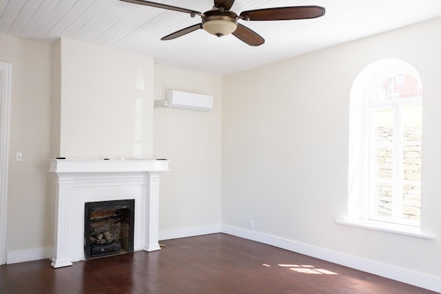 unfurnished living room with baseboards, a fireplace, dark wood-style flooring, and a wall mounted AC