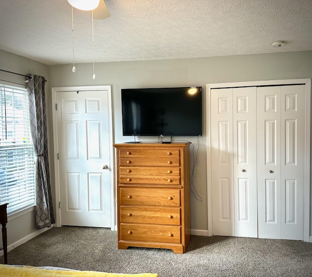 unfurnished bedroom featuring a closet, carpet flooring, and a textured ceiling