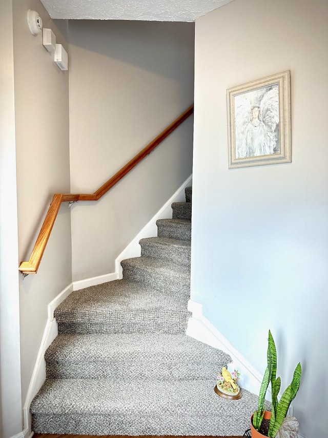 stairs featuring baseboards