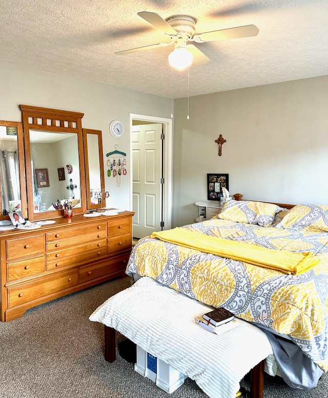 carpeted bedroom with a textured ceiling and ceiling fan