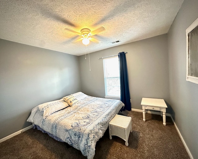 carpeted bedroom featuring visible vents, a textured ceiling, a ceiling fan, and baseboards