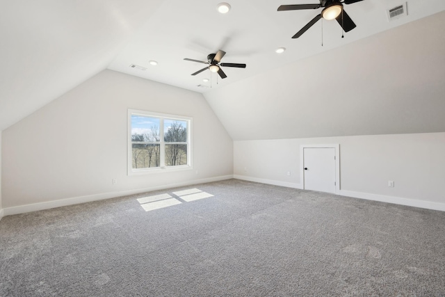 additional living space with lofted ceiling, baseboards, visible vents, and carpet floors