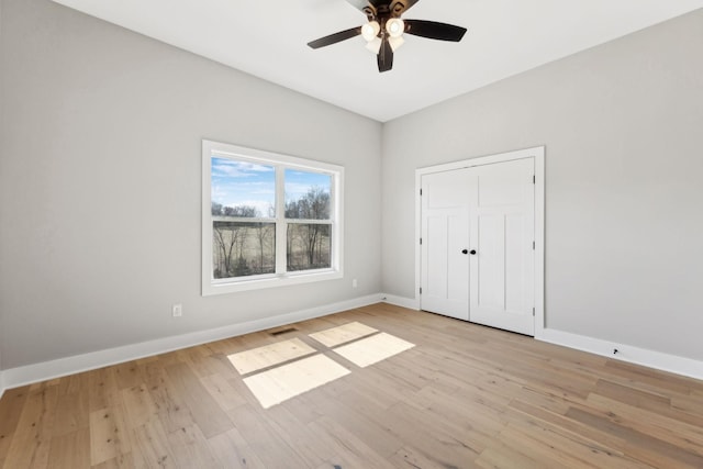 unfurnished bedroom featuring visible vents, light wood-type flooring, and baseboards