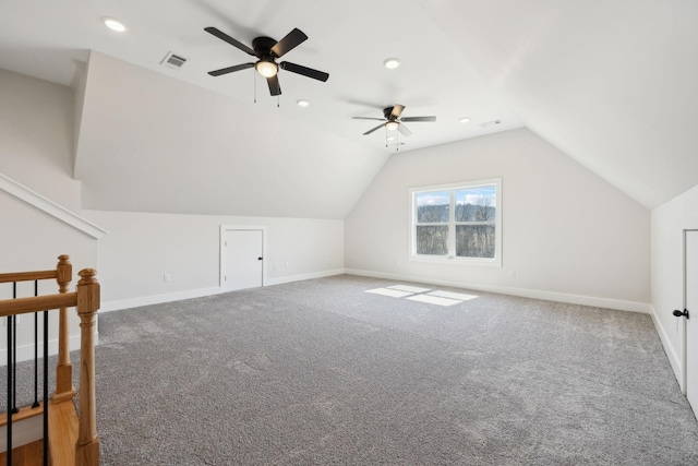 additional living space with visible vents, lofted ceiling, carpet floors, and baseboards