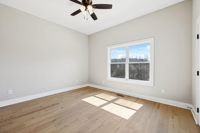 unfurnished room featuring visible vents, a ceiling fan, light wood-type flooring, and baseboards