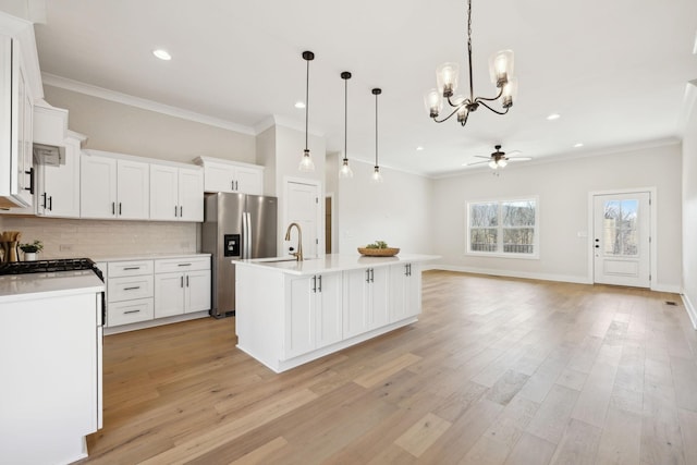 kitchen with backsplash, light wood-style flooring, stainless steel fridge with ice dispenser, and ornamental molding