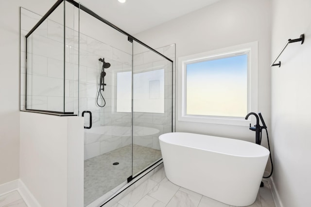 full bath featuring a stall shower, baseboards, marble finish floor, and a freestanding bath