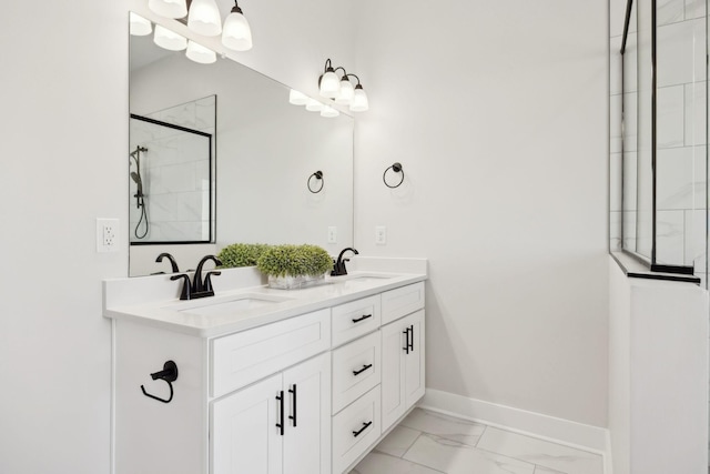 bathroom with a sink, baseboards, marble finish floor, and double vanity