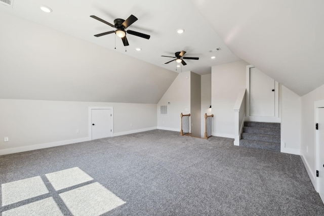 additional living space with visible vents, baseboards, and vaulted ceiling