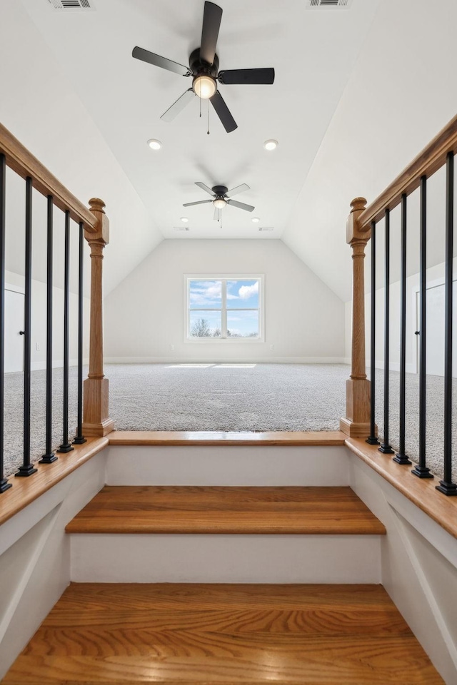 stairway featuring recessed lighting, visible vents, and vaulted ceiling