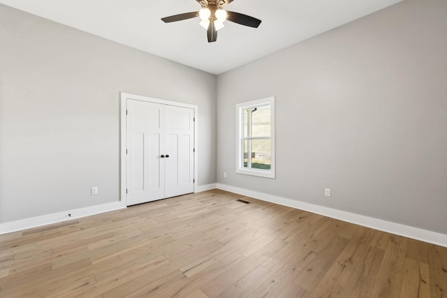 unfurnished bedroom with visible vents, baseboards, light wood-style flooring, ceiling fan, and a closet