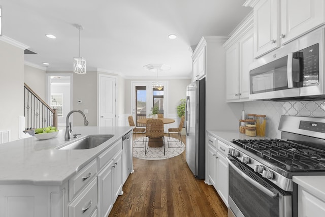 kitchen featuring a sink, crown molding, white cabinetry, and stainless steel appliances