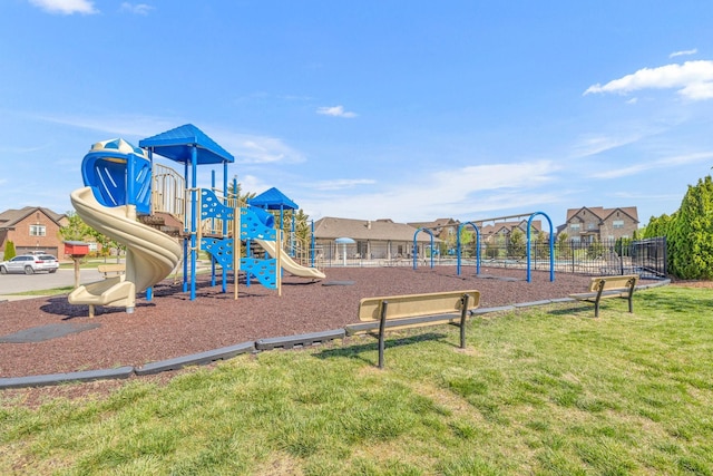 community playground with a yard and fence