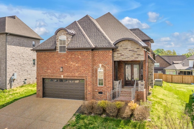 french country inspired facade featuring stone siding, french doors, concrete driveway, a garage, and brick siding