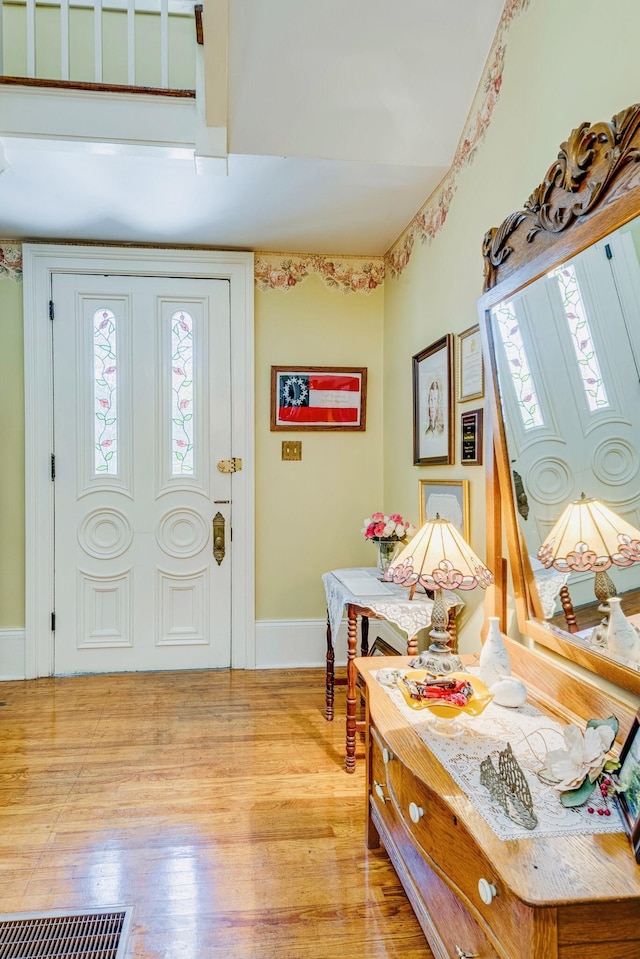 entryway featuring a wealth of natural light, visible vents, baseboards, and light wood-style flooring