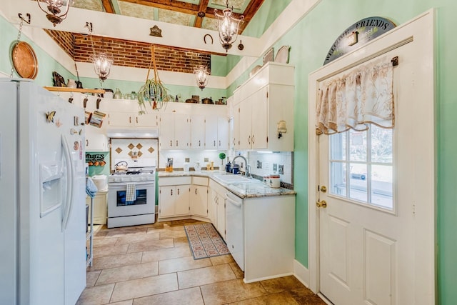 kitchen featuring a sink, under cabinet range hood, tasteful backsplash, white cabinetry, and white appliances