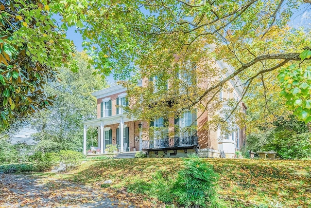 view of front facade featuring brick siding and covered porch