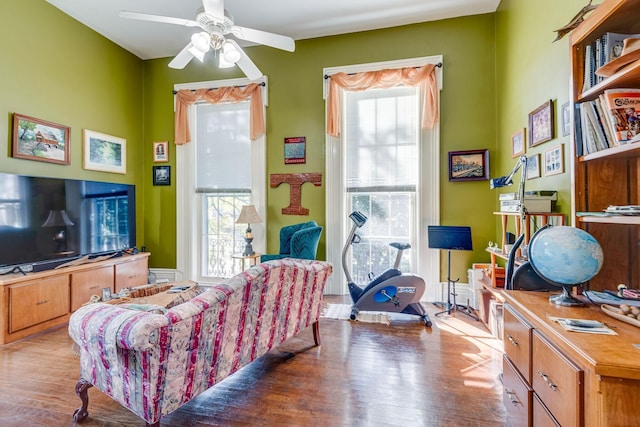 sitting room featuring a ceiling fan and wood finished floors