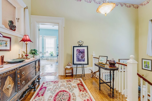 interior space with wood finished floors and an upstairs landing