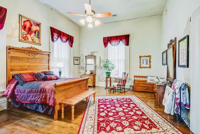 bedroom with visible vents, multiple windows, and wood finished floors