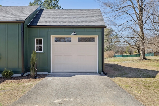 garage featuring aphalt driveway