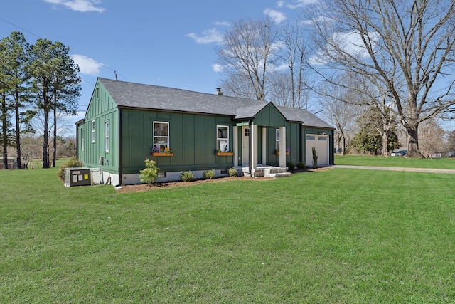 view of front of home with a front yard, a garage, board and batten siding, and crawl space