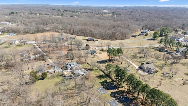 birds eye view of property featuring a rural view and a view of trees