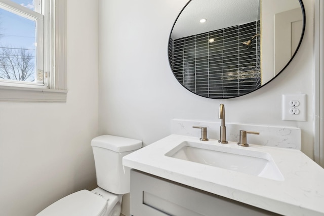 bathroom featuring toilet and vanity