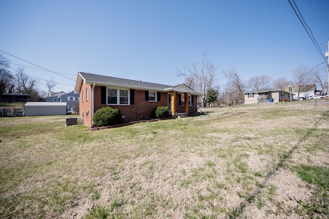 exterior space with a front lawn and brick siding