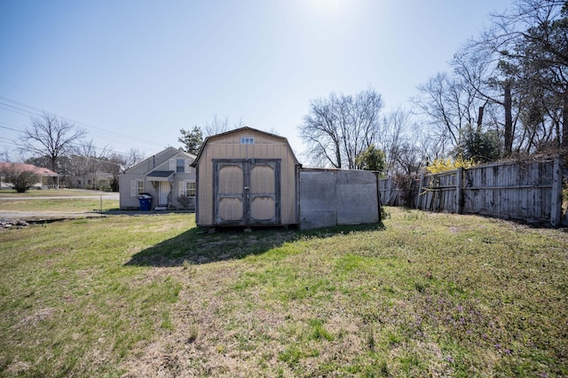 view of shed featuring fence