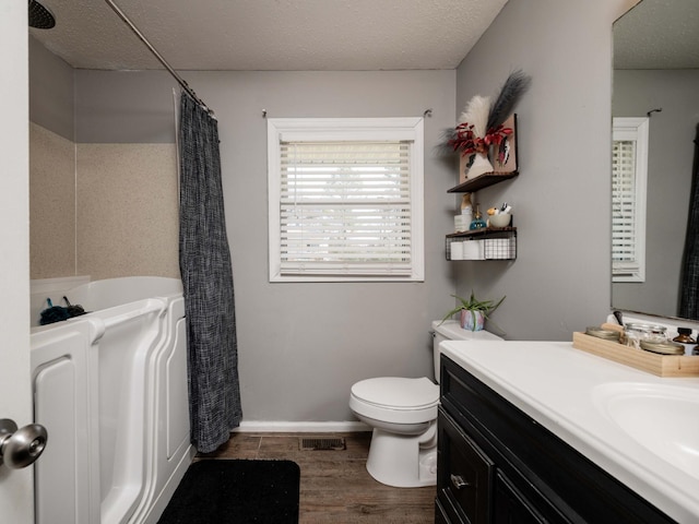 full bath with visible vents, toilet, a shower with curtain, wood finished floors, and vanity