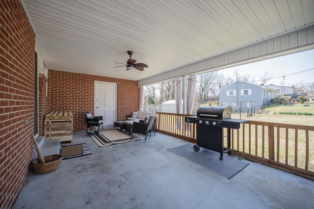 view of patio with an outbuilding, a ceiling fan, an outdoor living space, a storage unit, and grilling area