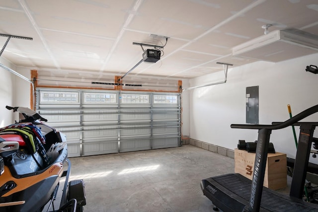 garage with electric panel and a garage door opener