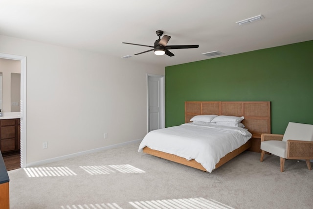 carpeted bedroom with visible vents, baseboards, and a ceiling fan