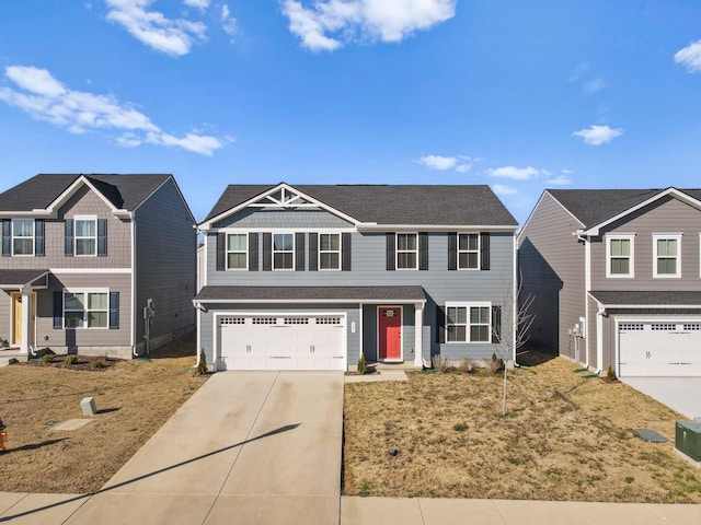 view of front of property featuring concrete driveway and a garage