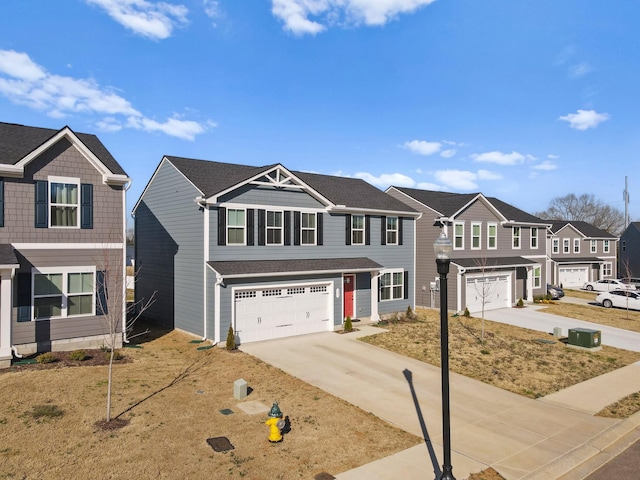 view of front of house with a residential view, driveway, and a garage