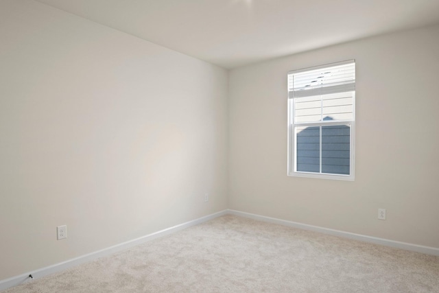 unfurnished room with baseboards and carpet floors