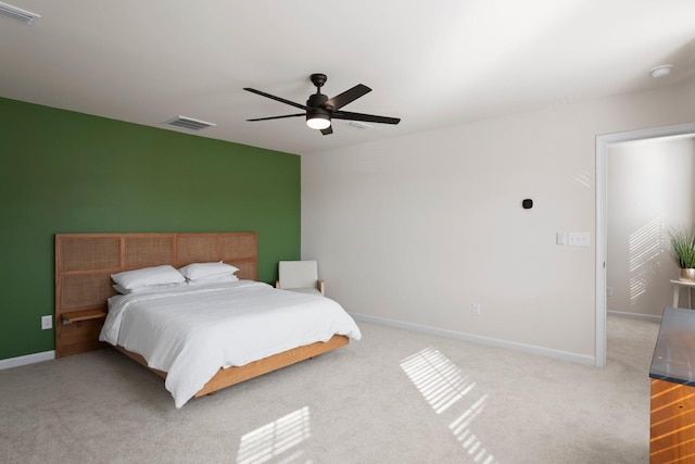 carpeted bedroom featuring visible vents, baseboards, and ceiling fan