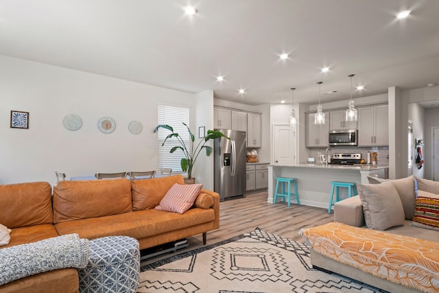 living room featuring recessed lighting and light wood-type flooring